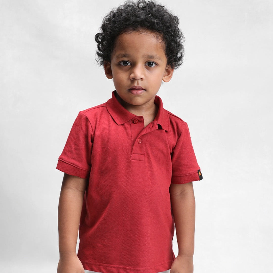 Kid wearing the clay classic polo