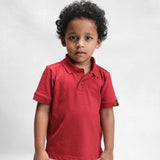 Kid wearing the clay classic polo