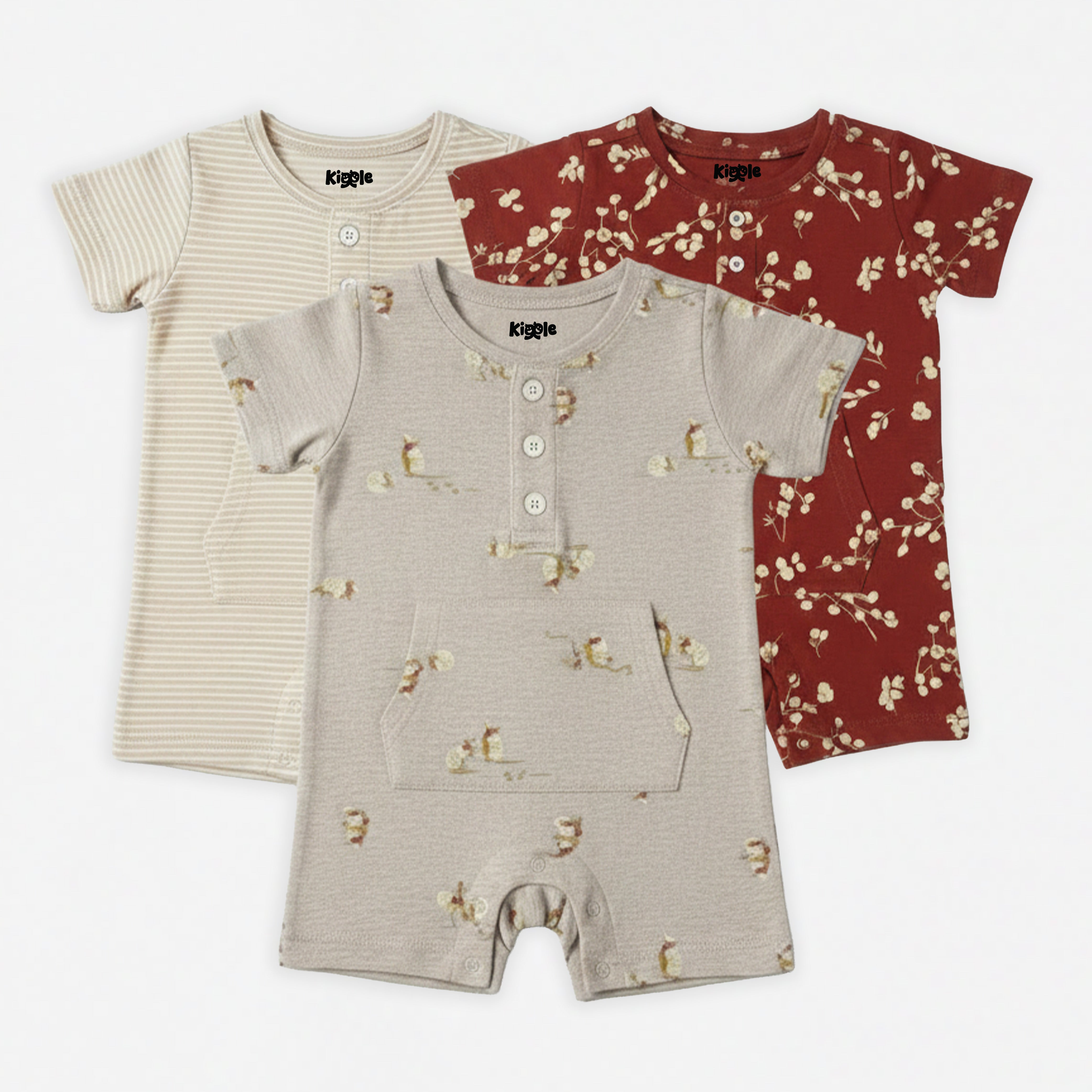 Pack of 3 organic cotton baby shorty rompers by Kiggle — armadillo print in oat, classic stripe in cream and beige, and berry branch in rust, sizes 3 to 24 months
